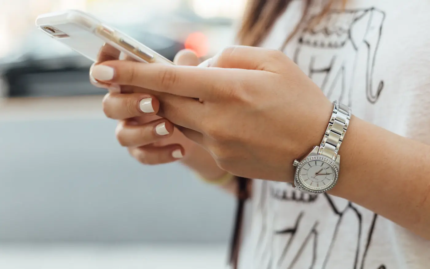 Hands holding a smartphone, thumbs ready to tap
